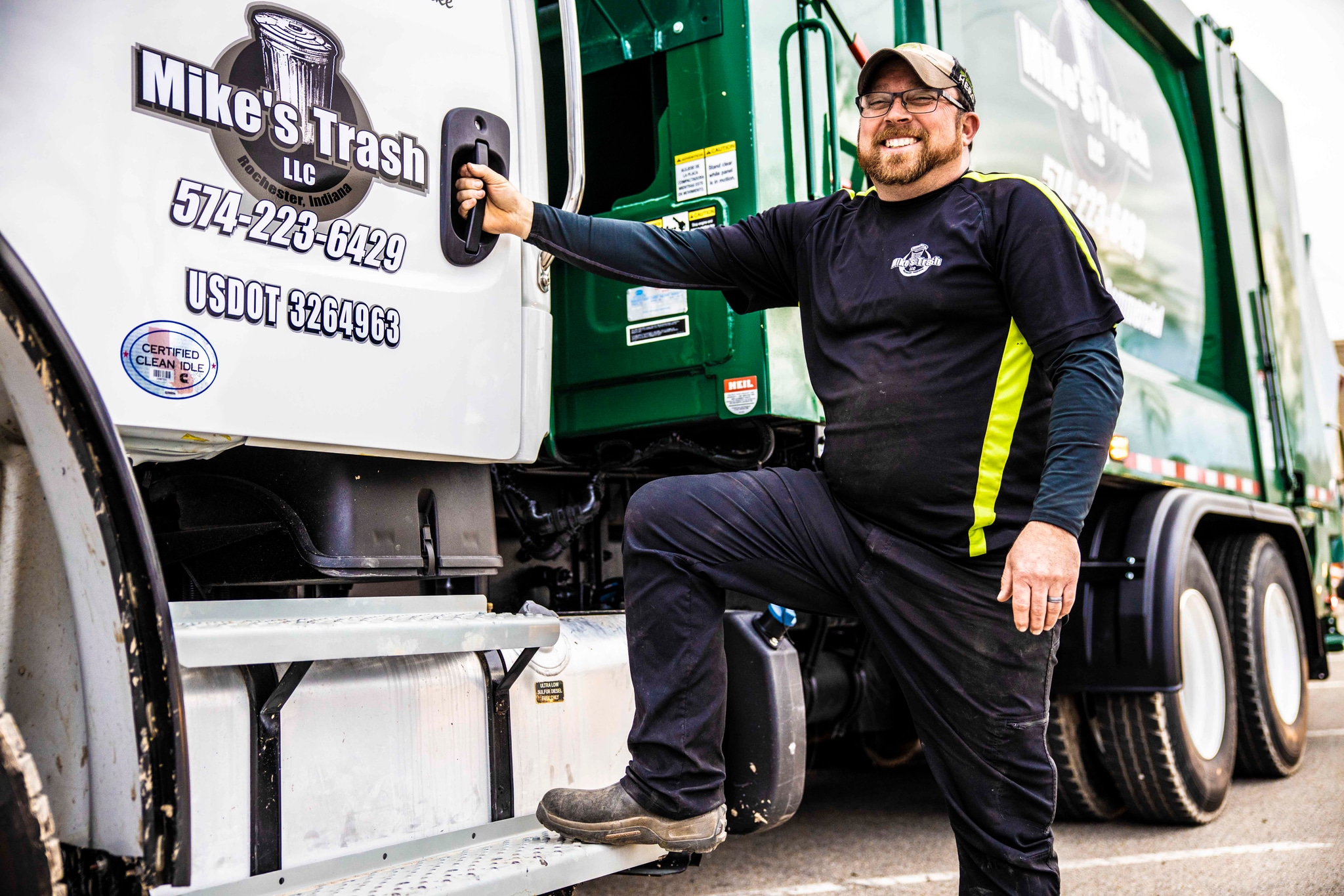 Owner with Mike's Trash truck
